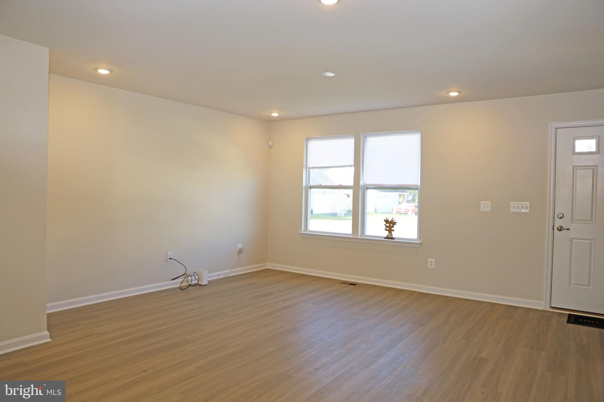 263 Ellery Street Ranson, WV 25438 - Photo 12 of 38 an empty room with wooden floor and windows