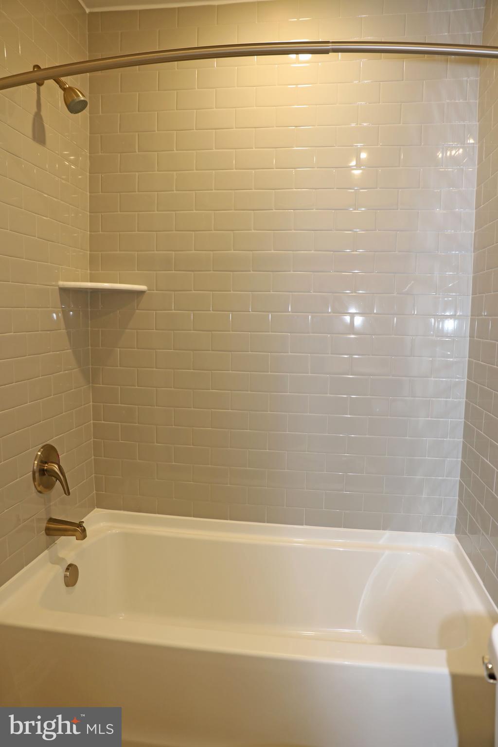 263 Ellery Street Ranson, WV 25438 - Photo 23 of 38 a bathroom with a shower and a bath tub