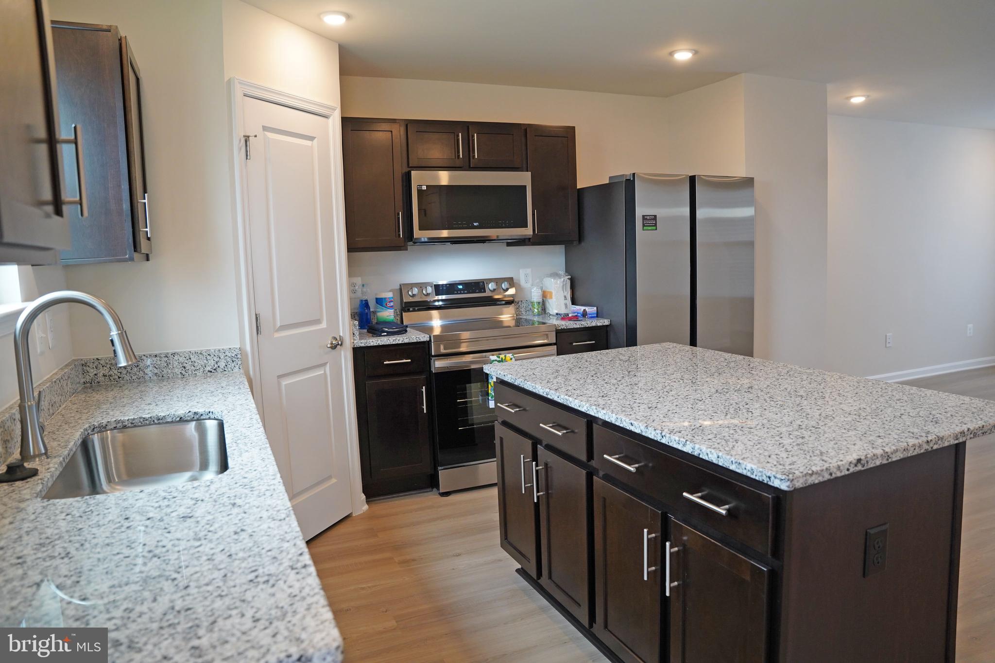 263 Ellery Street Ranson, WV 25438 - Photo 4 of 38 a kitchen with stainless steel appliances granite countertop a sink stove and refrigerator