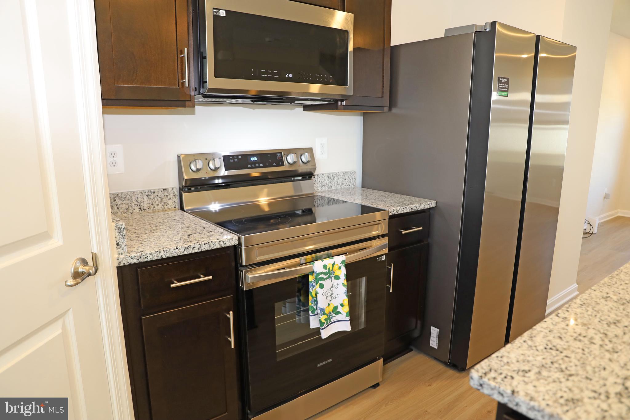263 Ellery Street Ranson, WV 25438 - Photo 5 of 38 a kitchen with stainless steel appliances granite countertop a refrigerator stove and microwave