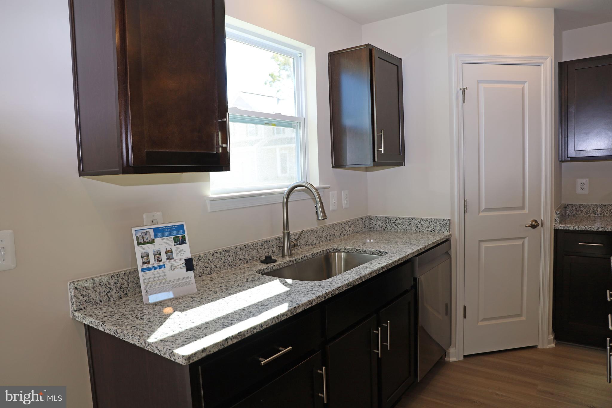 263 Ellery Street Ranson, WV 25438 - Photo 7 of 38 a kitchen with a sink and cabinets