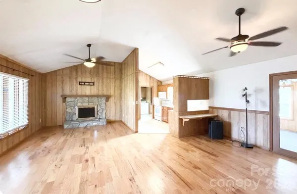 a view of a kitchen with a sink dishwasher and fireplace