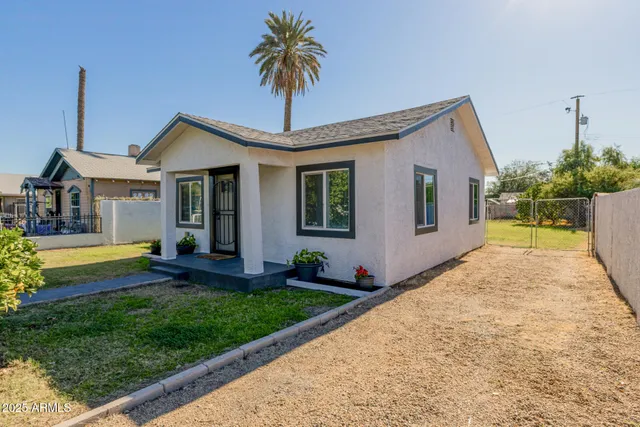 a front view of house with yard and outdoor seating
