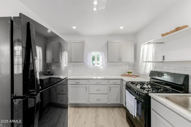 a kitchen with a sink stove and cabinets