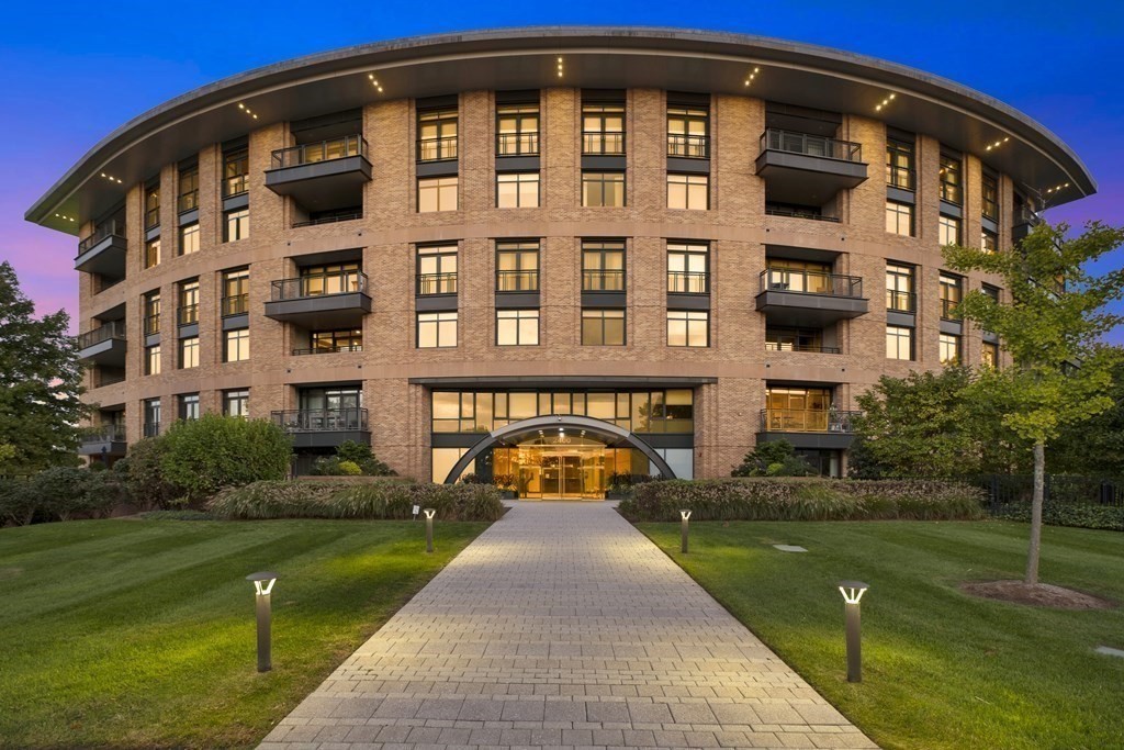 a front view of a building with a garden