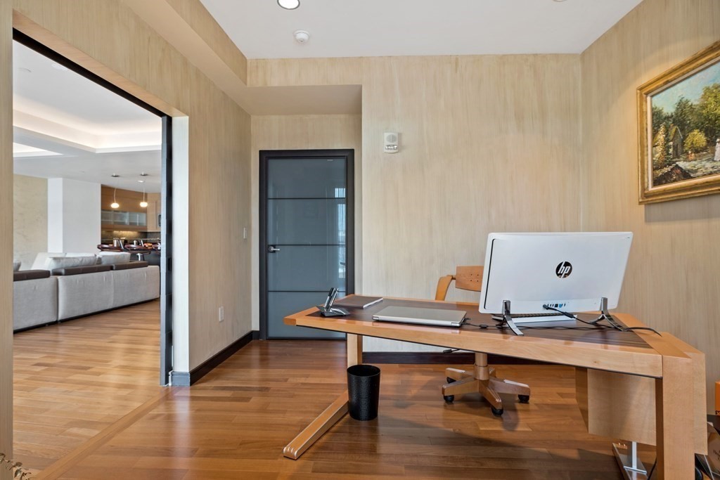 2400 Beacon Street, Unit 401 Boston, MA 02467 - Photo 12 of 35 a view of a workspace with furniture and wooden floor