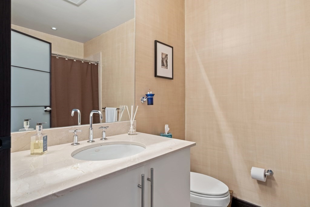 2400 Beacon Street, Unit 401 Boston, MA 02467 - Photo 15 of 35 a bathroom with a sink toilet and vanity
