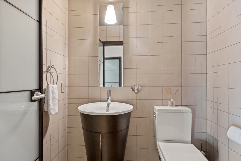 2400 Beacon Street, Unit 401 Boston, MA 02467 - Photo 18 of 35 a bathroom with a sink toilet and shower