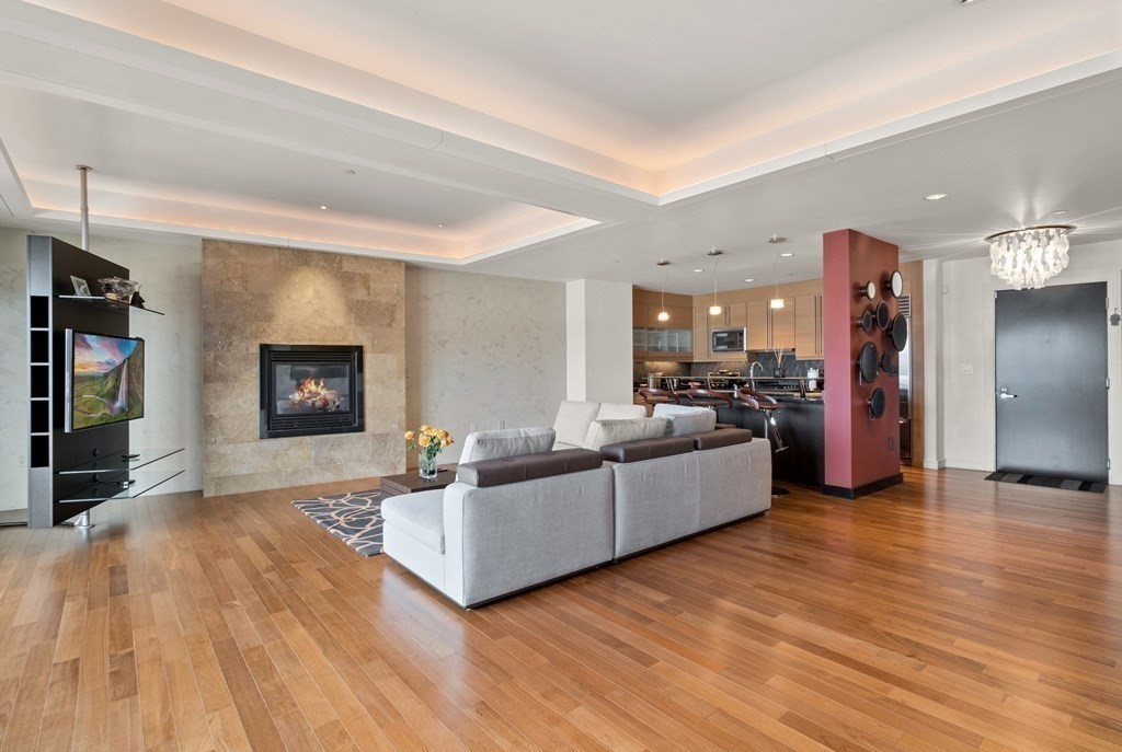 2400 Beacon Street, Unit 401 Boston, MA 02467 - Photo 2 of 35 a living room with furniture and a flat screen tv
