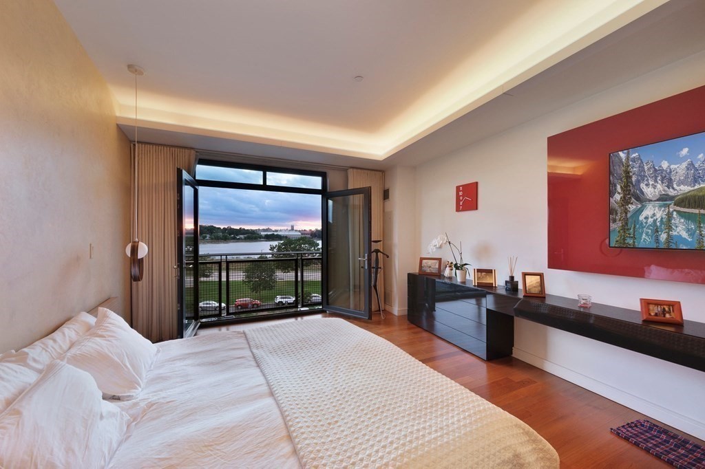 2400 Beacon Street, Unit 401 Boston, MA 02467 - Photo 23 of 35 a bedroom with a bed and glass windows