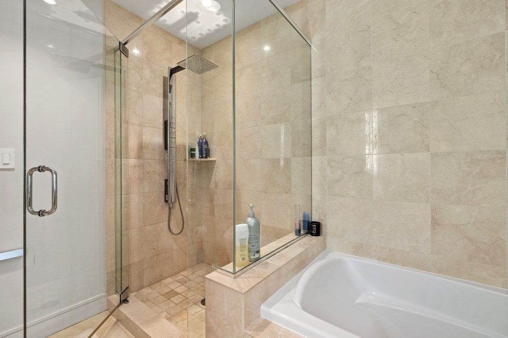 2400 Beacon Street, Unit 401 Boston, MA 02467 - Photo 25 of 35 a bathroom with a tub and shower