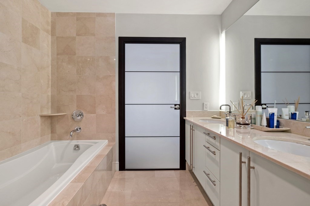 2400 Beacon Street, Unit 401 Boston, MA 02467 - Photo 27 of 35 a bathroom with a tub sink and mirror