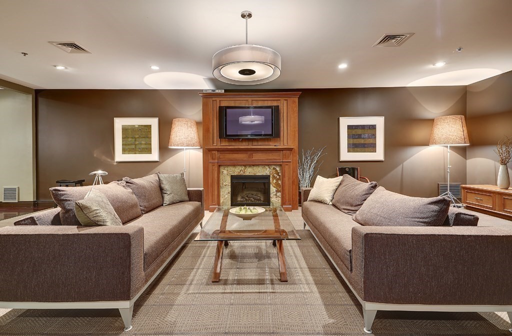 2400 Beacon Street, Unit 401 Boston, MA 02467 - Photo 31 of 35 a living room with furniture and a fireplace