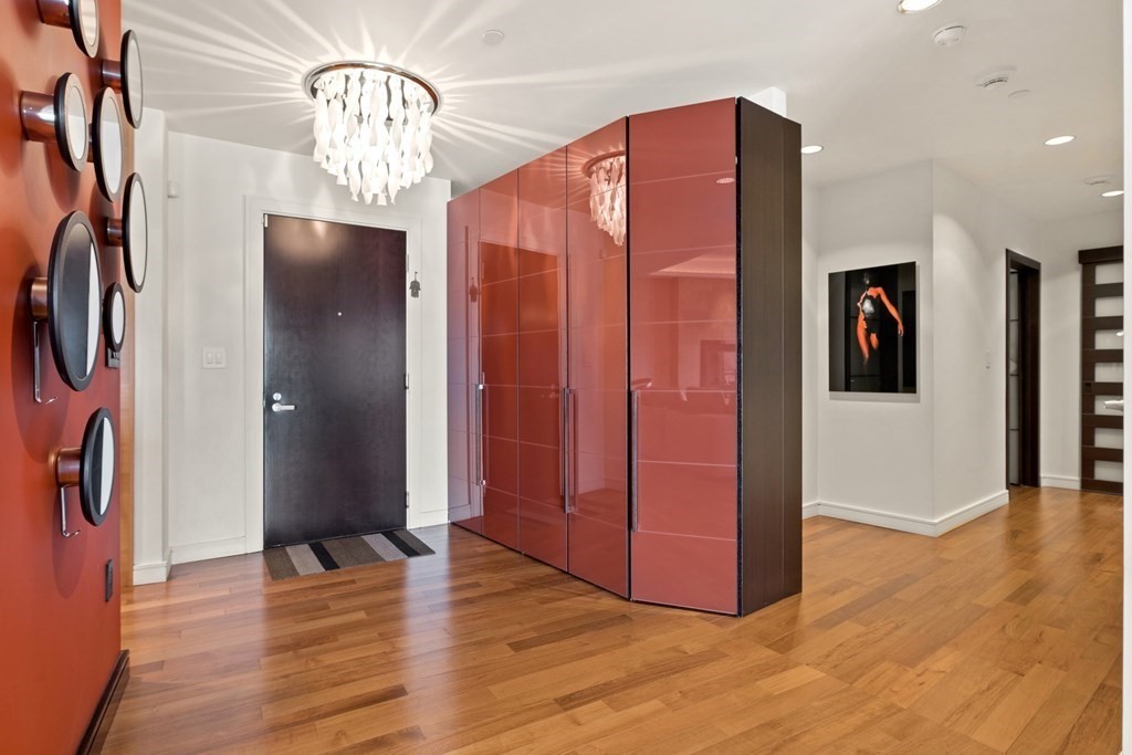 2400 Beacon Street, Unit 401 Boston, MA 02467 - Photo 7 of 35 a view of a hallway with wooden floor and chandelier
