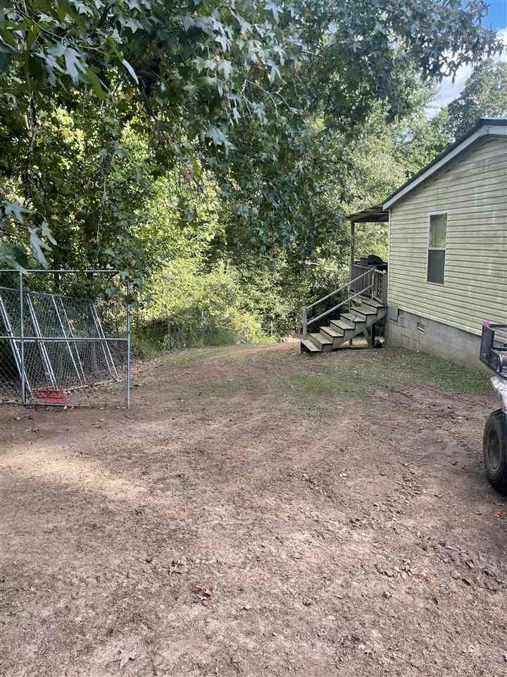 6884 Conner Whitefield Road Ripley, TN 38063 - Photo 16 of 16 a view of a backyard with table and chairs and a large tree