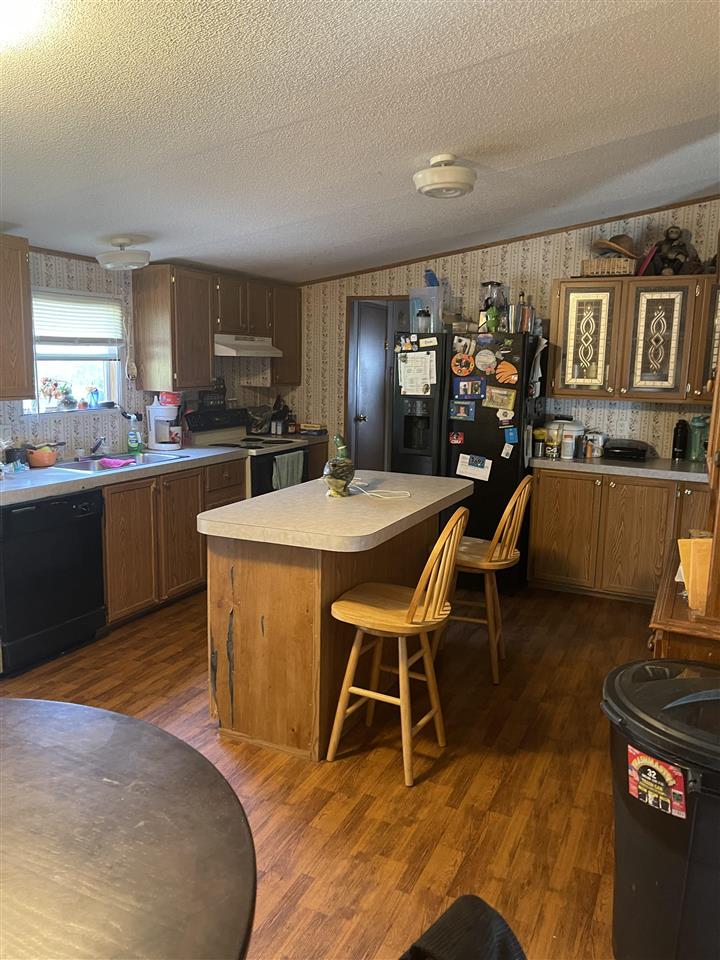 6884 Conner Whitefield Road Ripley, TN 38063 - Photo 3 of 16 a view of a dining room with furniture and wooden floor