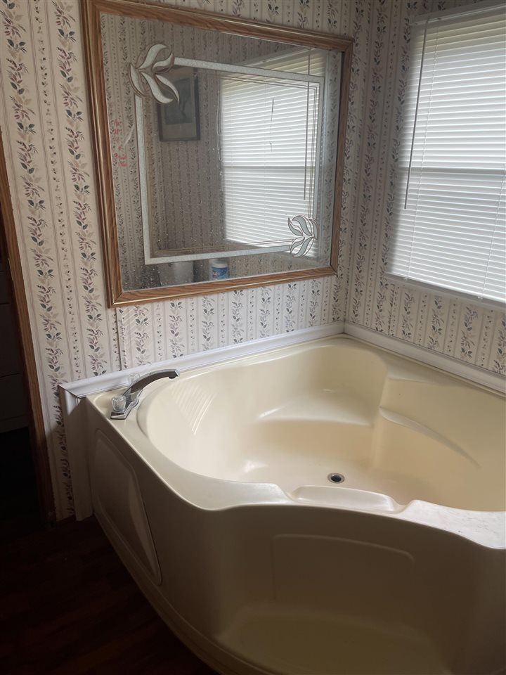 6884 Conner Whitefield Road Ripley, TN 38063 - Photo 8 of 16 a bath tub sitting in a bathroom next to a window