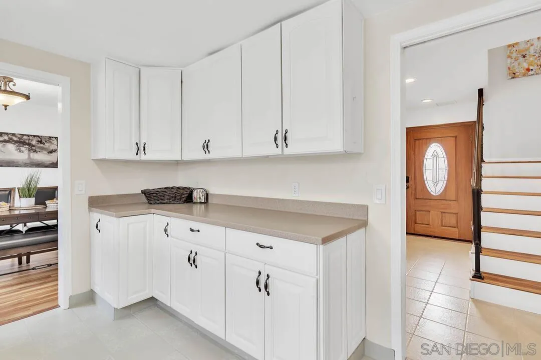 1668 Olmeda Street Encinitas, CA 92024 - Photo 12 of 42 a kitchen with granite countertop white cabinets and white appliances