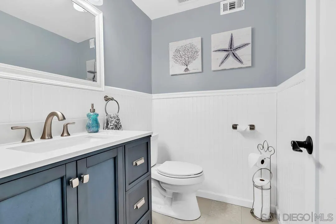 1668 Olmeda Street Encinitas, CA 92024 - Photo 15 of 42 a bathroom with a toilet sink and mirror
