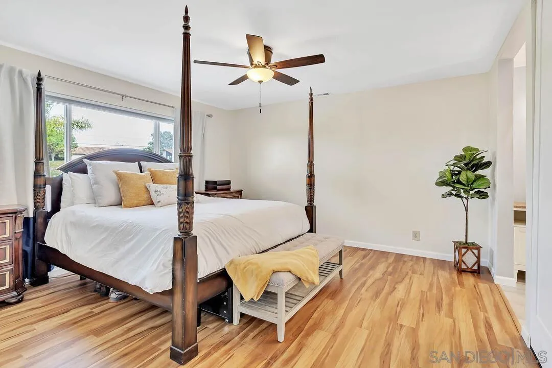 1668 Olmeda Street Encinitas, CA 92024 - Photo 19 of 42 a bed room with a bed and a potted plant