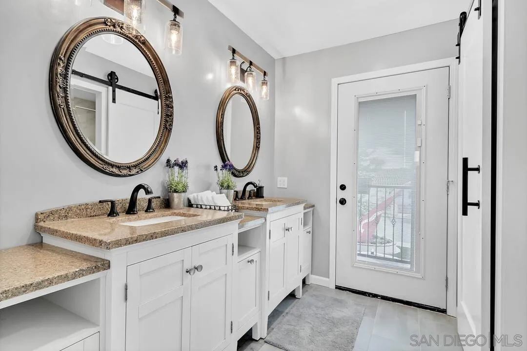 1668 Olmeda Street Encinitas, CA 92024 - Photo 22 of 42 a bathroom with a granite countertop sink and a mirror