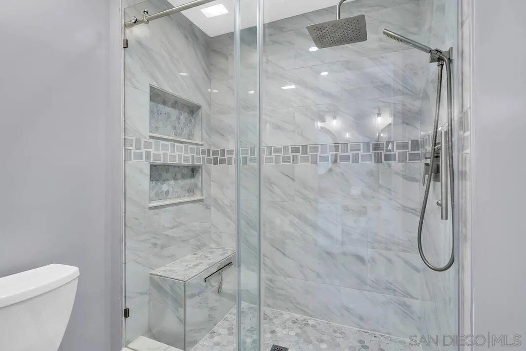 1668 Olmeda Street Encinitas, CA 92024 - Photo 23 of 42 a bathroom with a shower and toilet