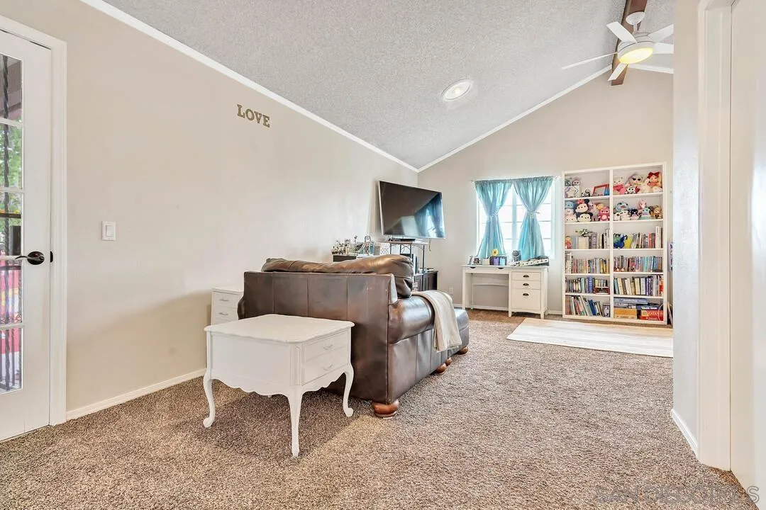 1668 Olmeda Street Encinitas, CA 92024 - Photo 27 of 42 a living room with furniture a chandelier and a dining table