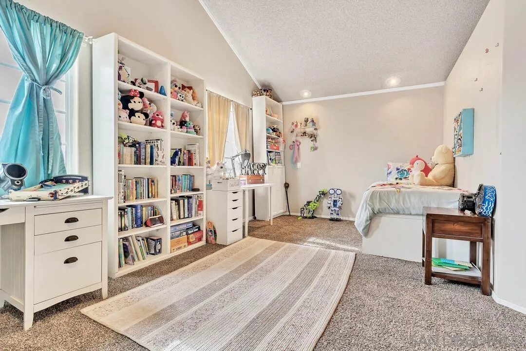 1668 Olmeda Street Encinitas, CA 92024 - Photo 29 of 42 a bedroom with furniture and a book shelf