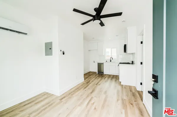 a view of empty room with wooden floor