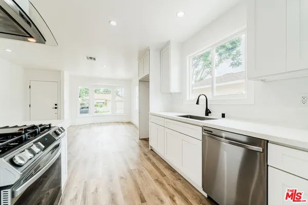 a kitchen that has a sink and a stove