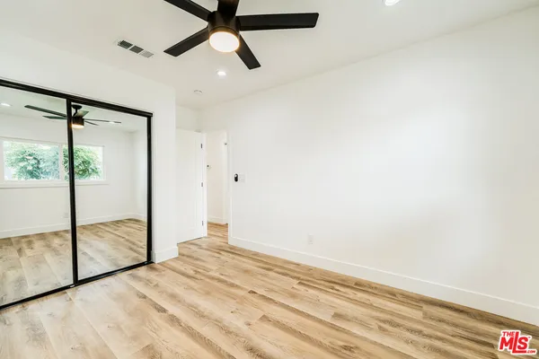 a view of a livingroom with a ceiling fan and window
