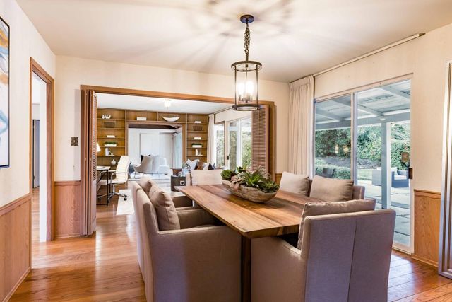 a view of a dining room with furniture window and wooden floor