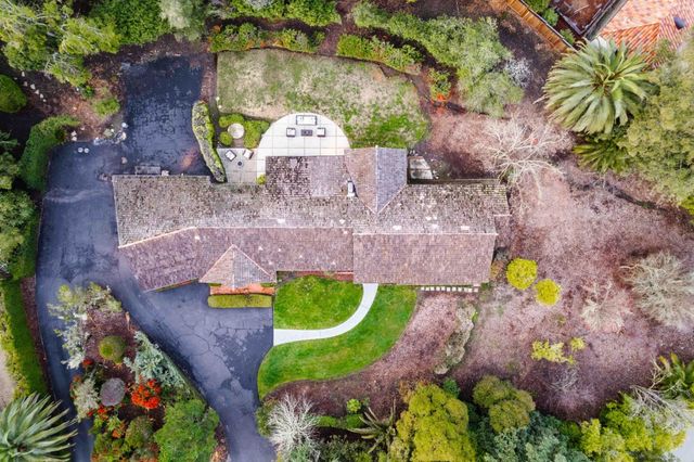 an aerial view of a house with a swimming pool