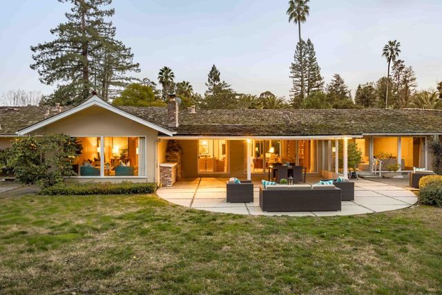 a view of a house with backyard and porch