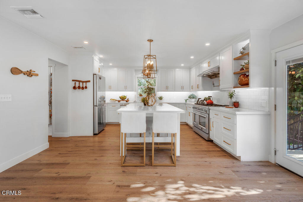 3500 Fairchild Street La Crescenta, CA 91214 - Photo 42 of 54 a dining room with kitchen island a dining table wooden floor and a sink