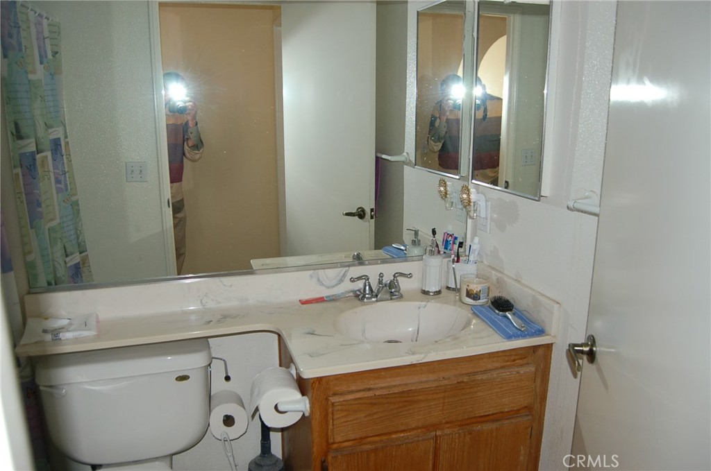 7731 Evans Street Riverside, CA 92504 - Photo 11 of 22 a bathroom with a sink and mirror