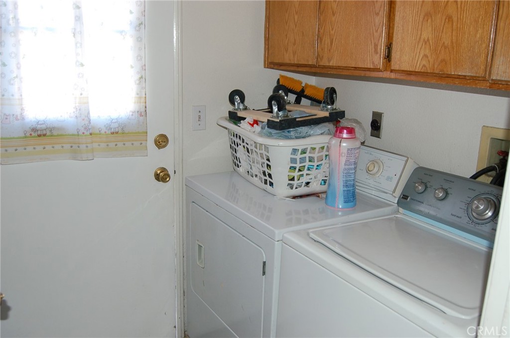 7731 Evans Street Riverside, CA 92504 - Photo 12 of 22 a utility room with cabinets washer and dryer