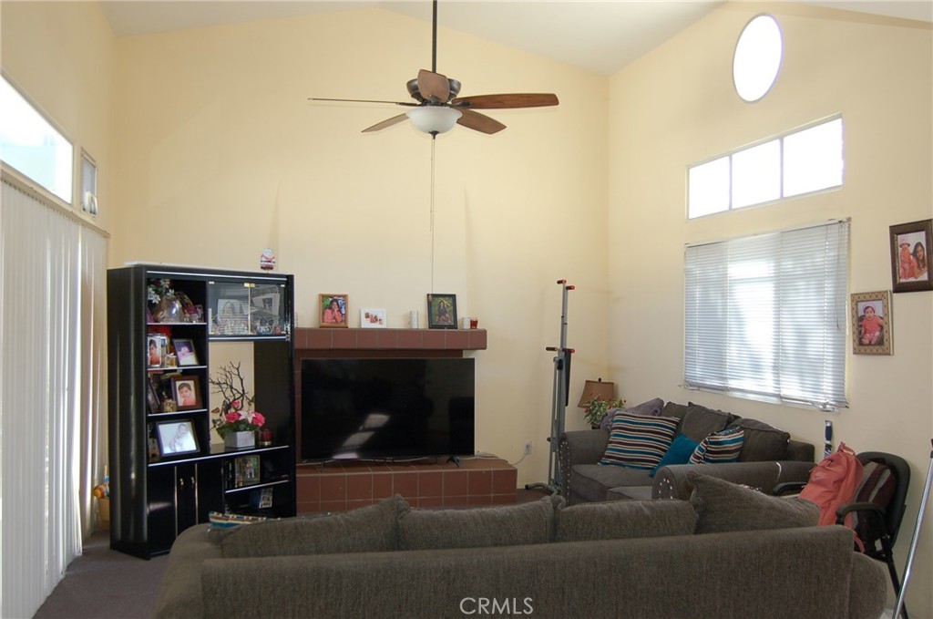 7731 Evans Street Riverside, CA 92504 - Photo 3 of 22 a living room with furniture a ceiling fan and a window