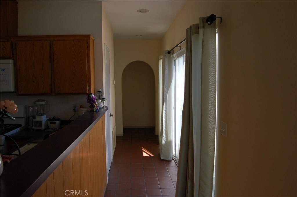7731 Evans Street Riverside, CA 92504 - Photo 5 of 22 a kitchen with a refrigerator and a stove top oven
