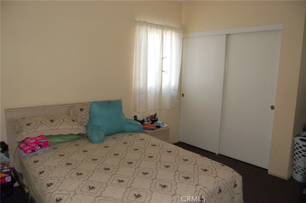 7731 Evans Street Riverside, CA 92504 - Photo 7 of 22 a bedroom with a bed and a window