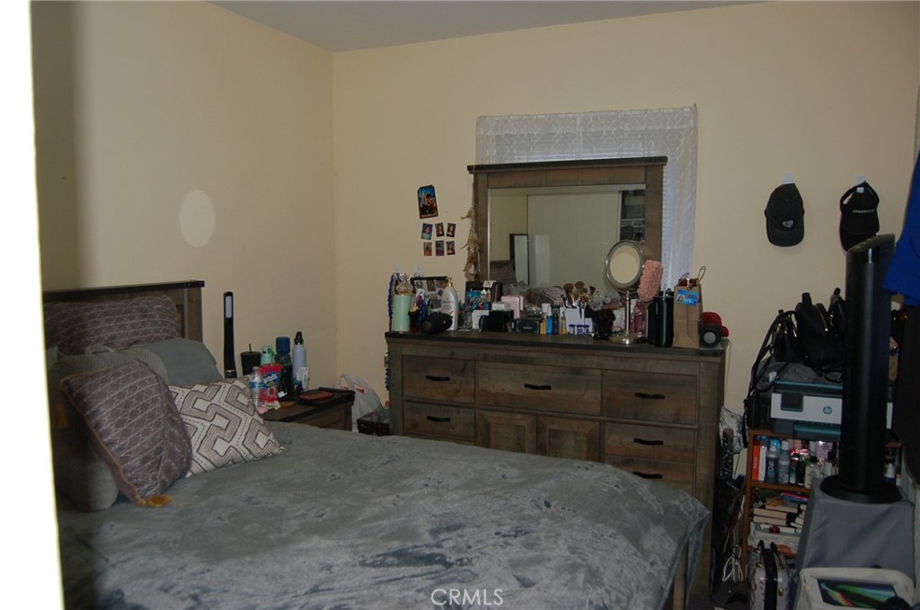 7731 Evans Street Riverside, CA 92504 - Photo 9 of 22 a bed room with furniture and a mirror