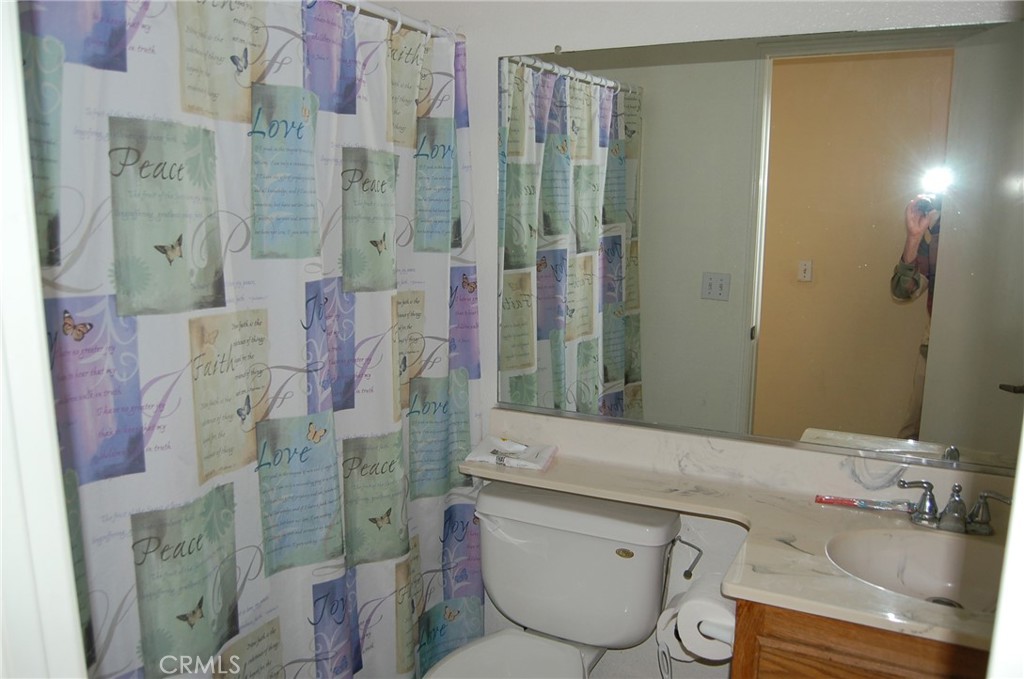 7731 Evans Street Riverside, CA 92504 - Photo 10 of 22 a bathroom with a granite countertop shower a sink and toilet