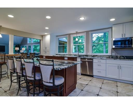 75 Evergreen Road Natick, MA 01760 - Photo 12 of 36 a kitchen with lots of counter top space dining table and chairs