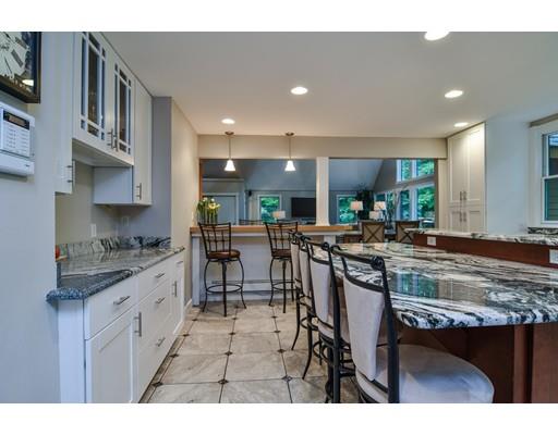 75 Evergreen Road Natick, MA 01760 - Photo 13 of 36 a kitchen with stainless steel appliances granite countertop a table and chairs in it