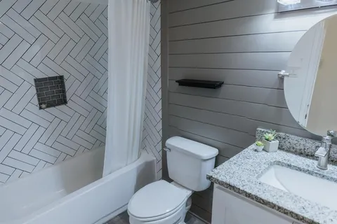 a white toilet sitting next to a bathroom sink