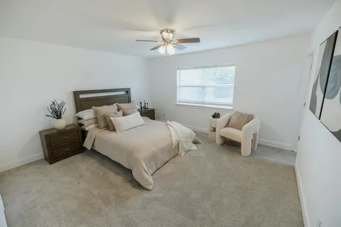 a bedroom with bed and a window