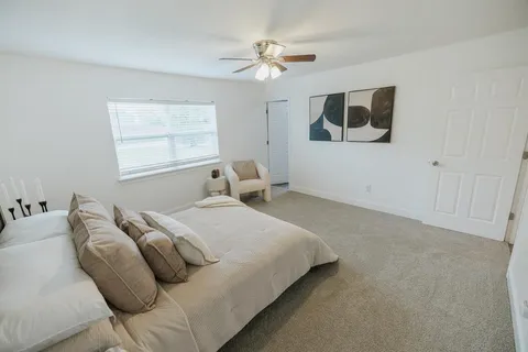 a bedroom with a bed and a ceiling fan