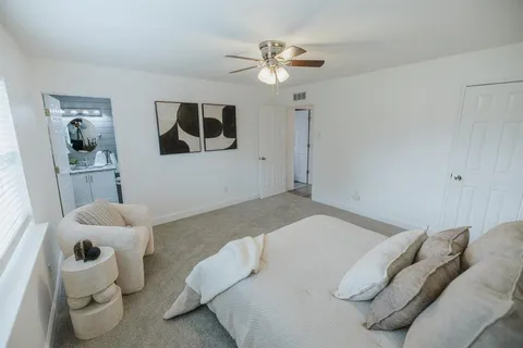 a bedroom with a bed and cabinets