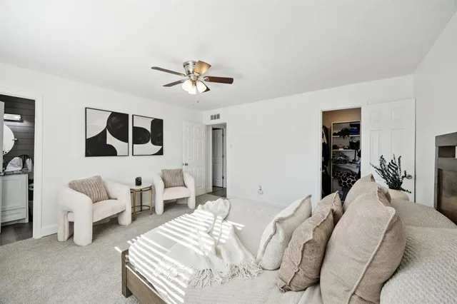 a bedroom with furniture and a large mirror