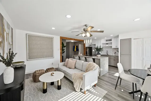 a living room with furniture and kitchen view